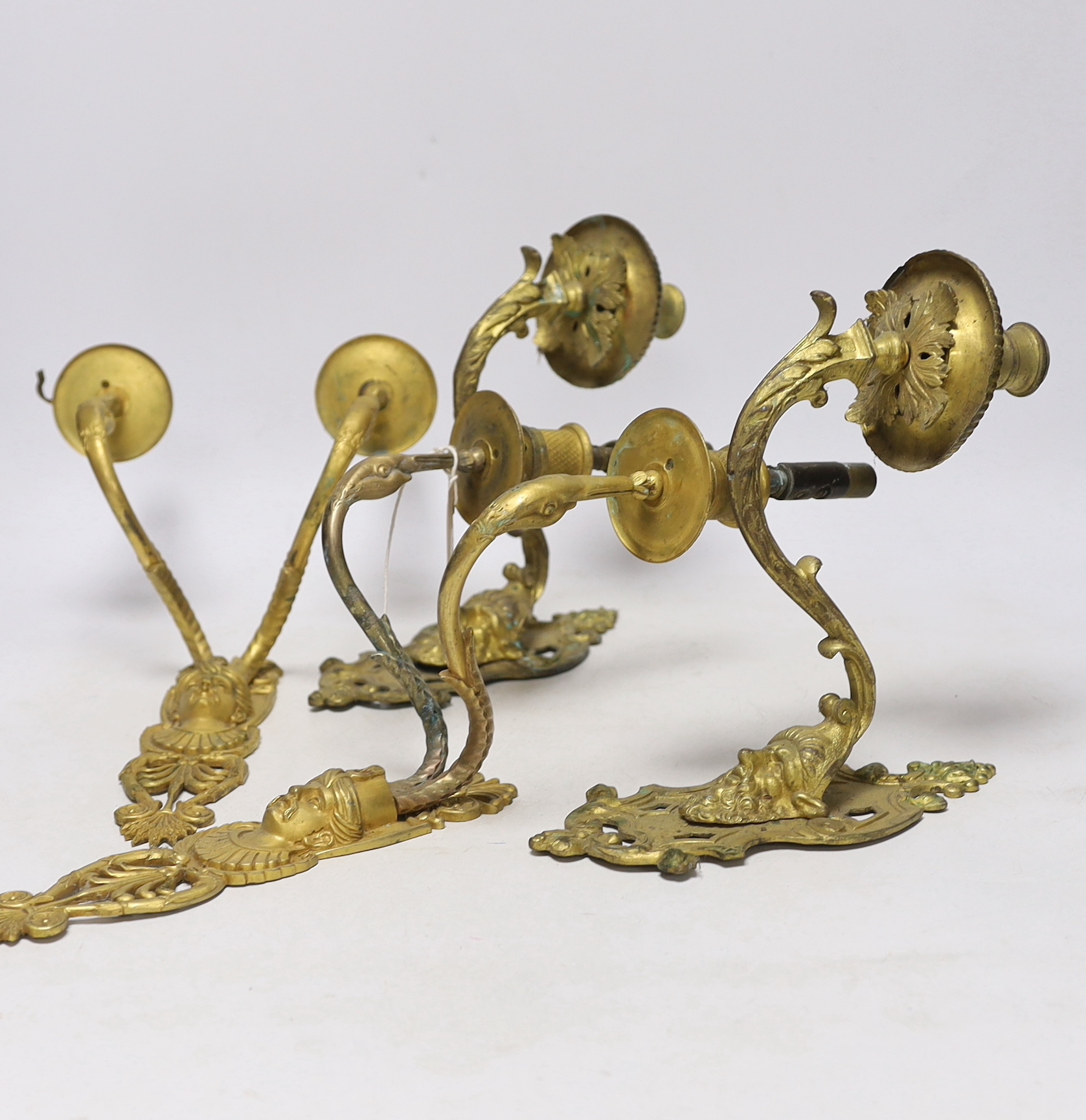 A pair of ormolu two branch wall lights, a pair of single branch mask wall lights and a small pair of wall lights, largest 32cm high